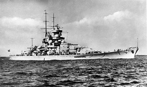 Period photograph: a battleship under way at sea, seen from the side