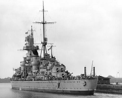 Period photograph: a cruiser in a canal lock beside a concrete lock wall