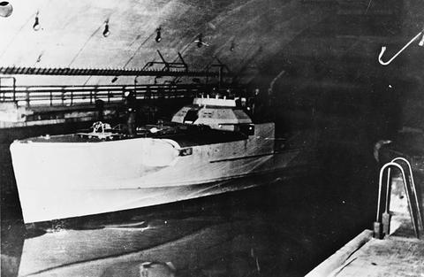 Period photograph: a motor torpedo boat moored inside a concrete shelter
