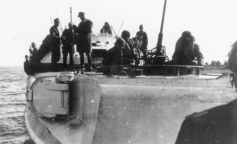 Period photograph: soldiers and sailors crowded on the deck of a boat at sea