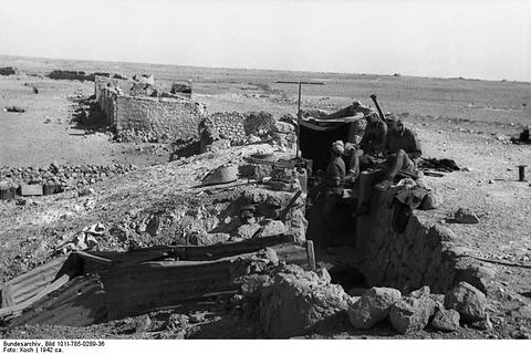 Period photograph: soldiers in a stone-walled position on top of a ruin
