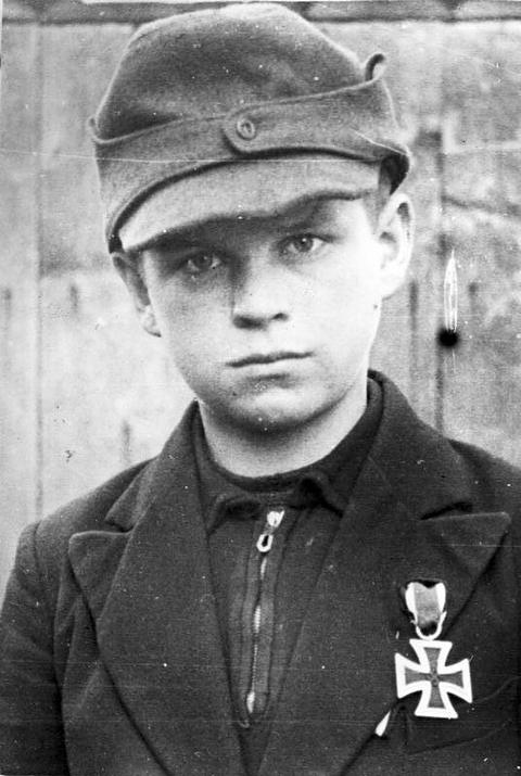 Period photograph: portrait of a boy in a field cap with an Iron Cross on his tunic